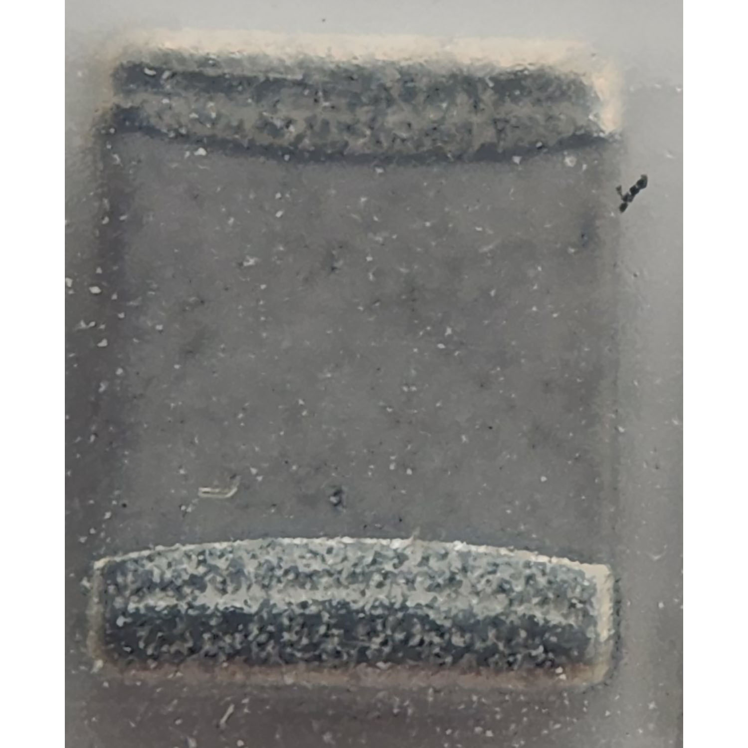 Motorola 2111078B29 RF ceramic capacitor showing rectangular surface mount body with end terminations