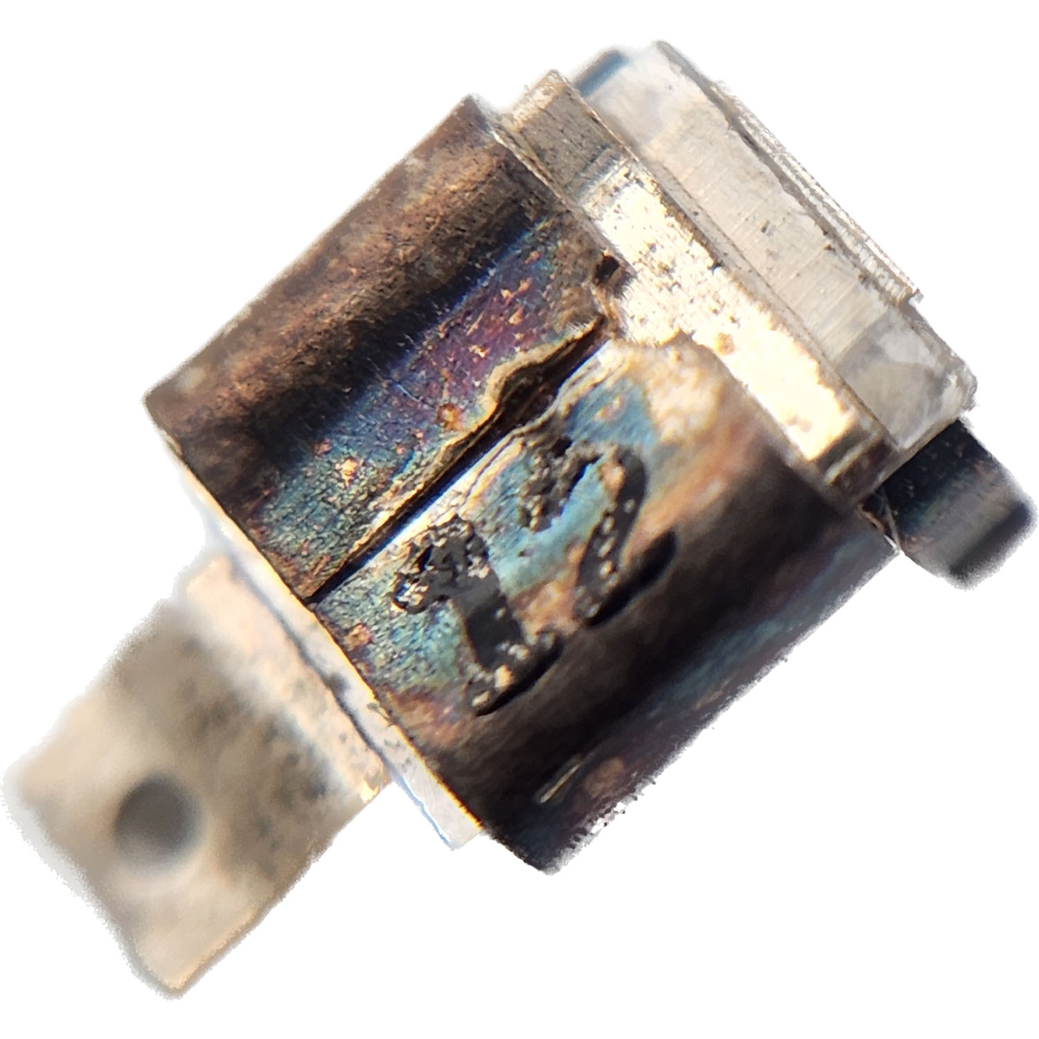 Motorola 2180240G20 mica capacitor close-up showing metal cladding construction and connection terminals